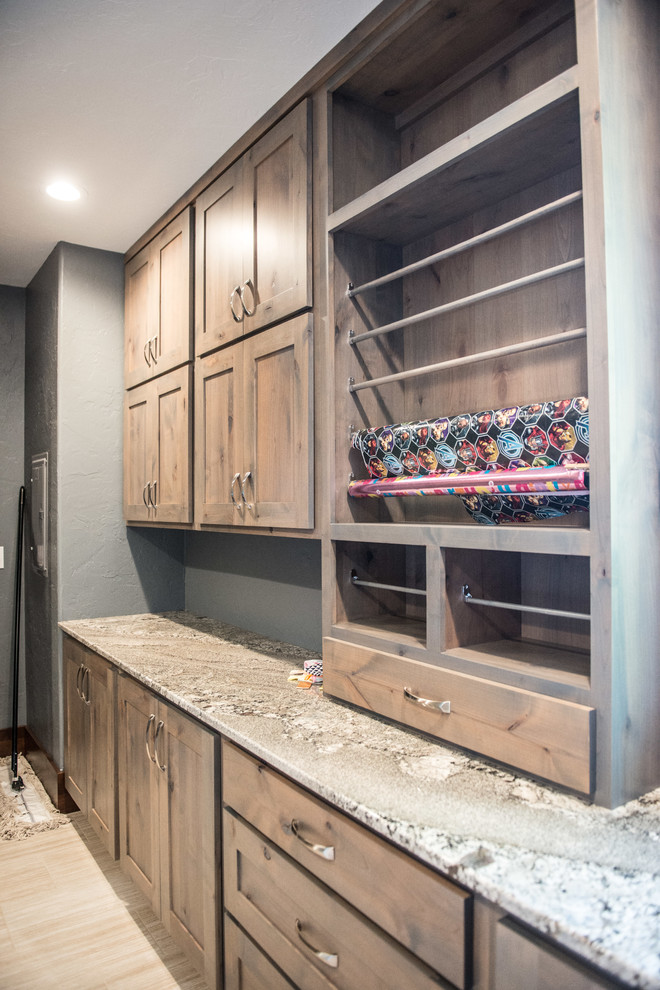 Utility room - huge rustic u-shaped gray floor utility room idea with an undermount sink, flat-panel cabinets, light wood cabinets, granite countertops, blue walls, a side-by-side washer/dryer and multicolored countertops