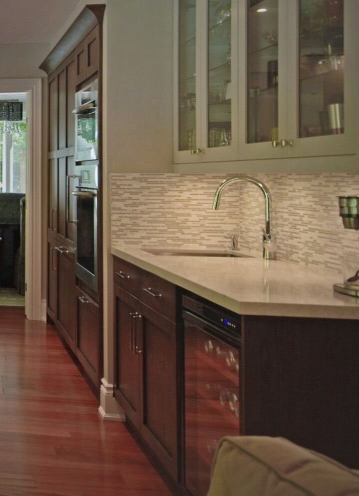 Inspiration for a transitional medium tone wood floor open concept kitchen remodel with a single-bowl sink, recessed-panel cabinets, quartz countertops, multicolored backsplash, paneled appliances, an island and white countertops