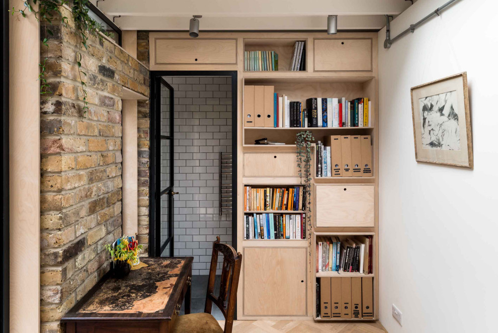 Photo of a contemporary home office in London with a feature wall.