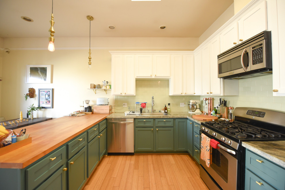 Inspiration for a small timeless l-shaped brown floor eat-in kitchen remodel in San Francisco with flat-panel cabinets, wood countertops, green backsplash, ceramic backsplash, no island and brown countertops