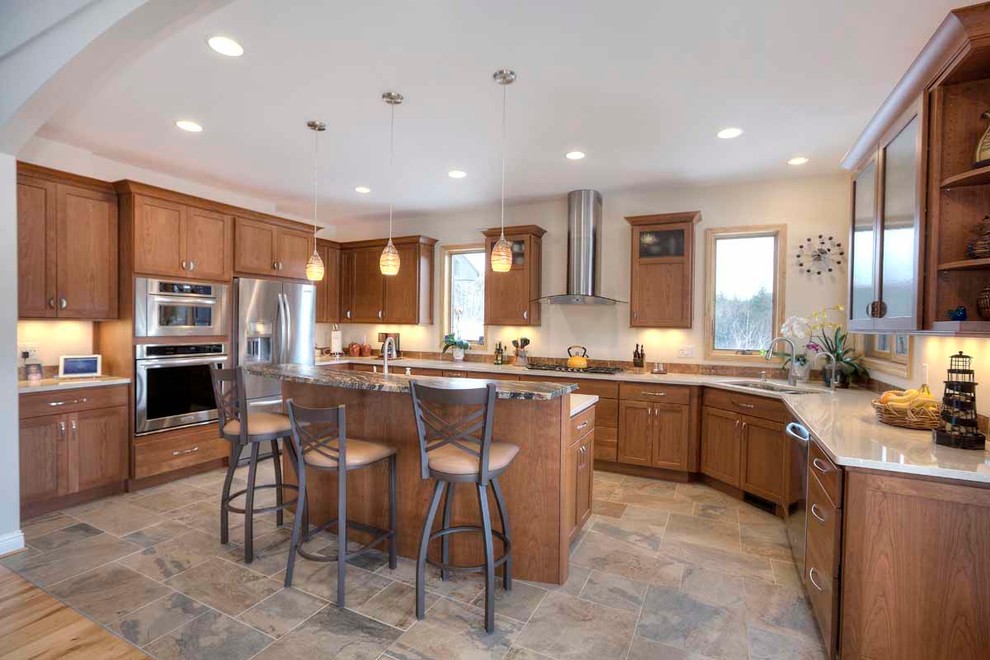 Example of a mid-sized transitional u-shaped slate floor kitchen design with an undermount sink, flat-panel cabinets, medium tone wood cabinets, quartz countertops, brown backsplash, stone tile backsplash, stainless steel appliances and an island