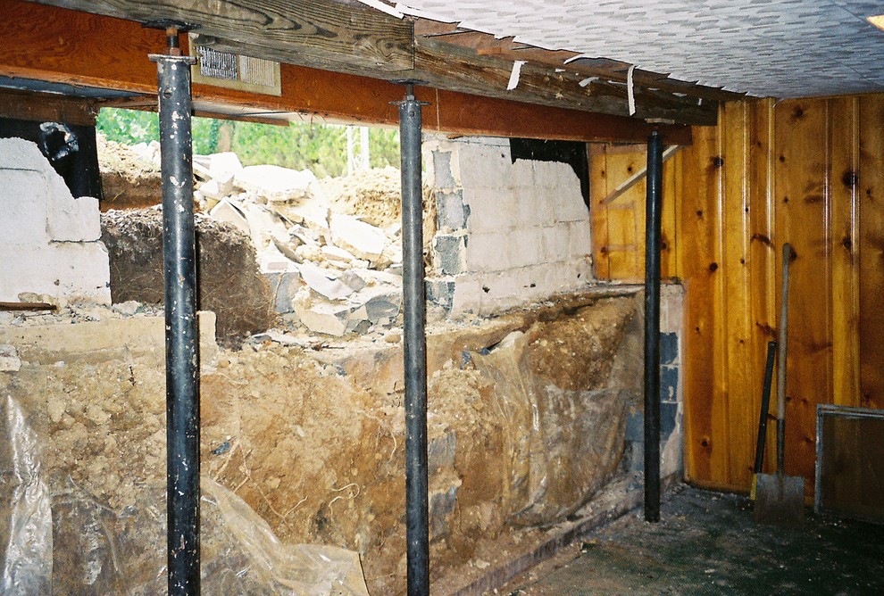 Inspiration for an underground concrete floor and gray floor basement remodel with multicolored walls