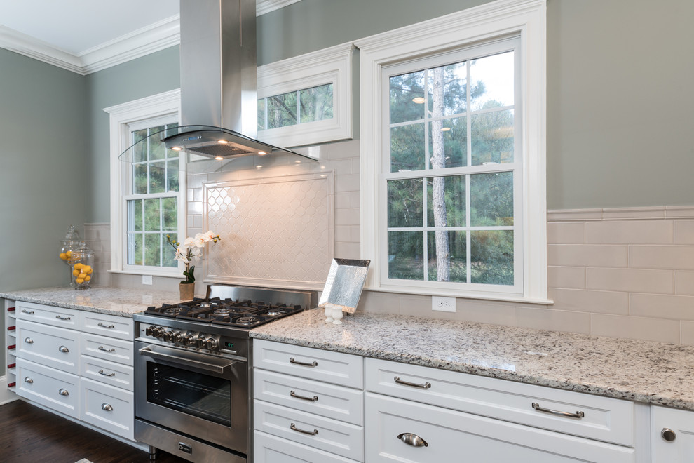Eat-in kitchen - huge transitional l-shaped dark wood floor and brown floor eat-in kitchen idea in Atlanta with an undermount sink, recessed-panel cabinets, white cabinets, granite countertops, gray backsplash, porcelain backsplash, stainless steel appliances, an island and white countertops