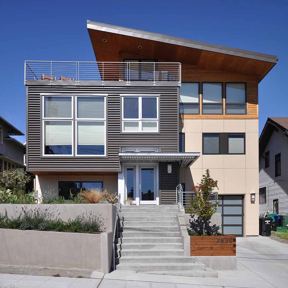 Design ideas for a mid-sized contemporary split-level exterior in Seattle with metal siding.