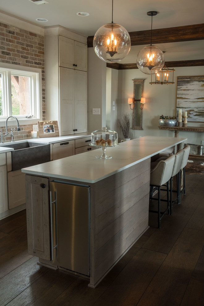 Inspiration for a large transitional galley dark wood floor and brown floor open concept kitchen remodel with a farmhouse sink, shaker cabinets, quartz countertops, brown backsplash, brick backsplash, stainless steel appliances and an island