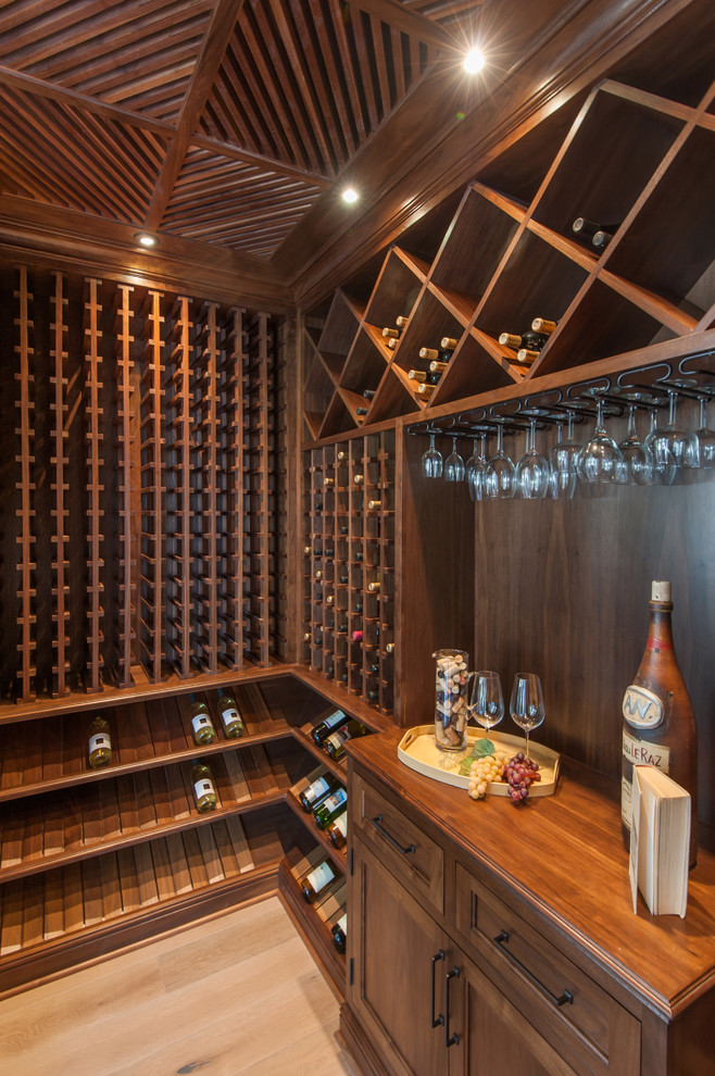 This is an example of a mid-sized traditional wine cellar in Los Angeles with medium hardwood floors and display racks.