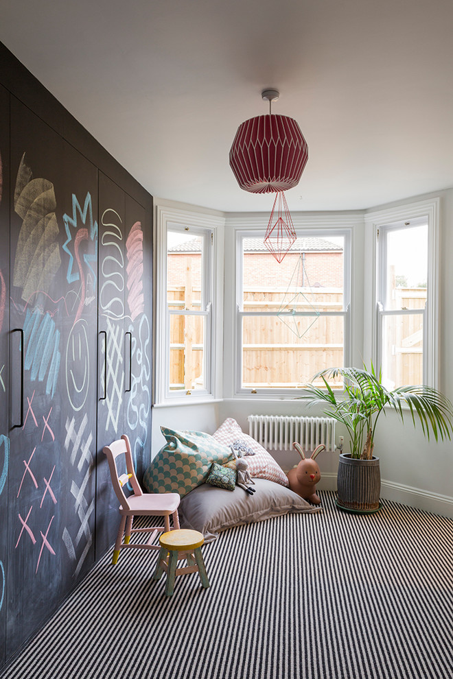 Eclectic kids' playroom in London with carpet and multi-coloured floor for kids 4-10 years old and girls.