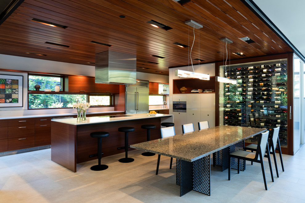 Photo of a modern kitchen in Seattle with an undermount sink, flat-panel cabinets, medium wood cabinets, quartzite benchtops, white splashback, stainless steel appliances, porcelain floors and with island.