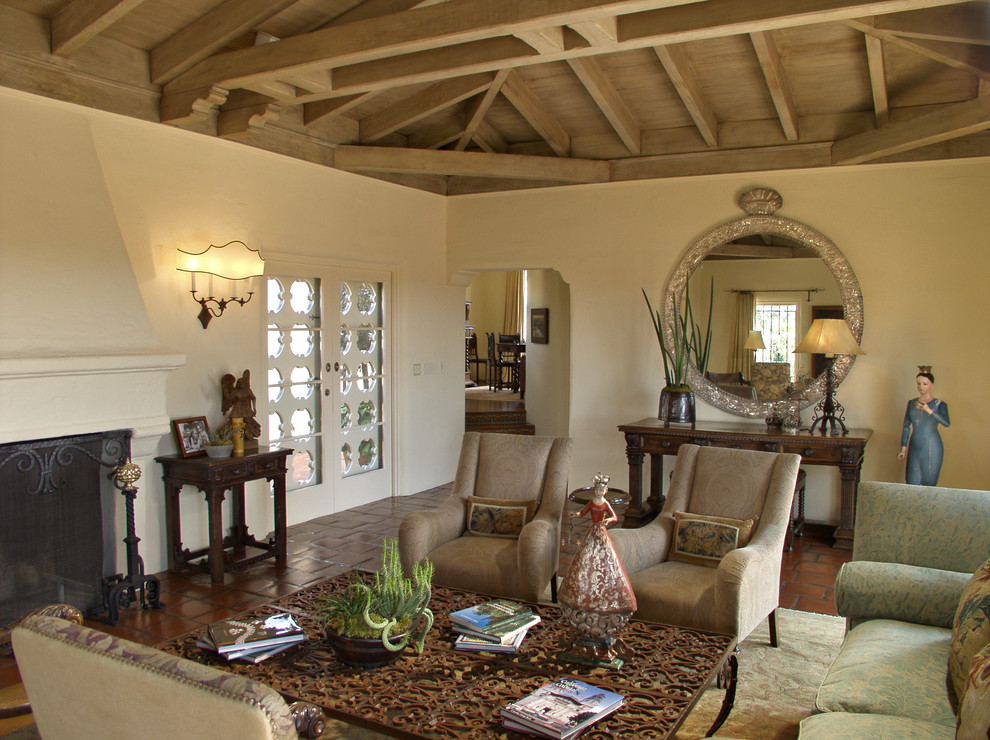 Inspiration for a mid-sized mediterranean formal enclosed living room in San Diego with white walls, terra-cotta floors, a standard fireplace, a plaster fireplace surround, no tv and red floor.