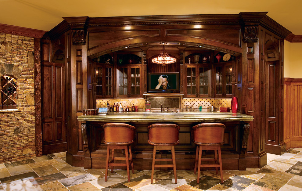 Inspiration for a mid-sized traditional single-wall seated home bar in Atlanta with an undermount sink, shaker cabinets, dark wood cabinets, granite benchtops, beige splashback, ceramic splashback, slate floors and multi-coloured floor.