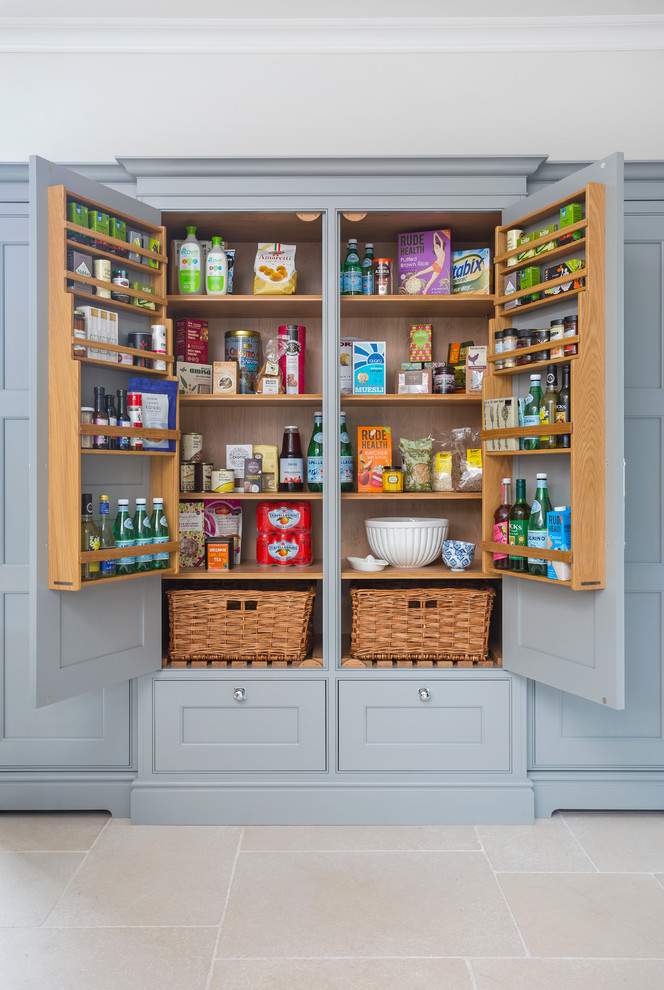 Photo of an expansive country kitchen pantry in Hampshire with flat-panel cabinets, grey cabinets, granite benchtops and limestone floors.