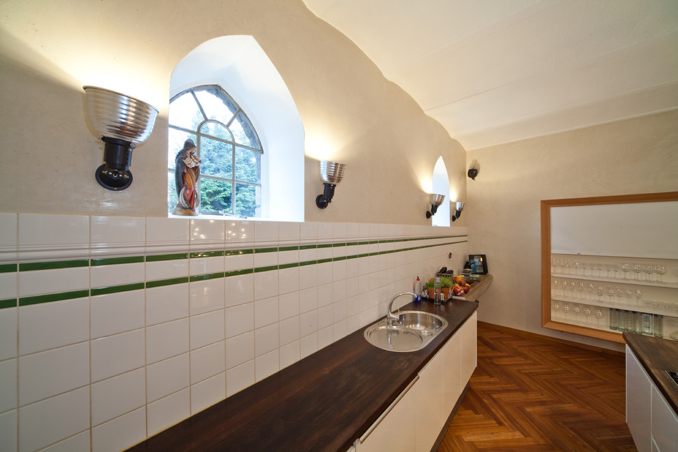 Design ideas for a large mediterranean open plan dining in Bonn with beige walls and medium hardwood floors.