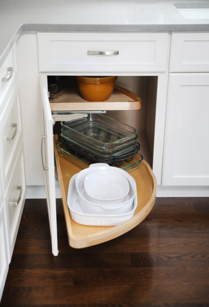 Transitional medium tone wood floor and brown floor eat-in kitchen photo in Chicago with shaker cabinets, white cabinets, quartz countertops and gray countertops