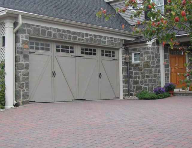 This is an example of a mid-sized traditional attached two-car garage in Boston.