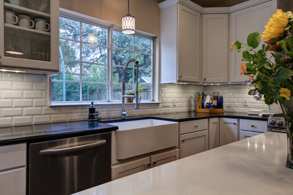 Eat-in kitchen - transitional u-shaped eat-in kitchen idea in Austin with a farmhouse sink, recessed-panel cabinets, white cabinets, quartz countertops, white backsplash, subway tile backsplash and stainless steel appliances
