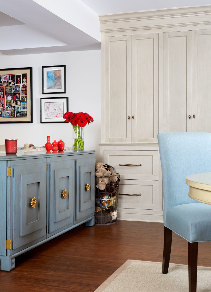 #mcleanrenovation - Basement Rec Room with Toy Storage - Bright and cheerful basement rec room with beige sectional, game table, built-in storage, and aqua and red accents.

Photo by Stacy Zarin Goldberg Photography