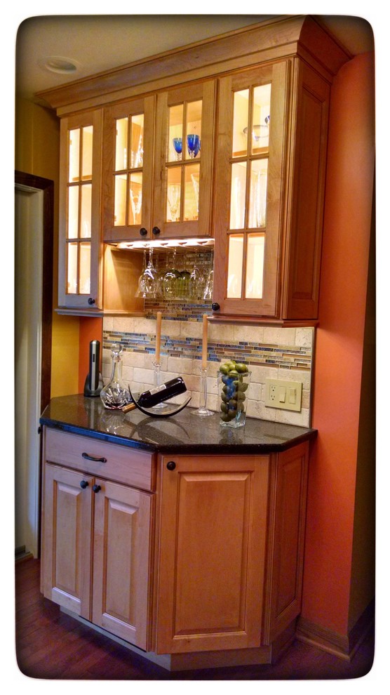 Inspiration for a large medium tone wood floor eat-in kitchen remodel with glass-front cabinets, light wood cabinets, quartz countertops, beige backsplash, stone tile backsplash, stainless steel appliances and an island