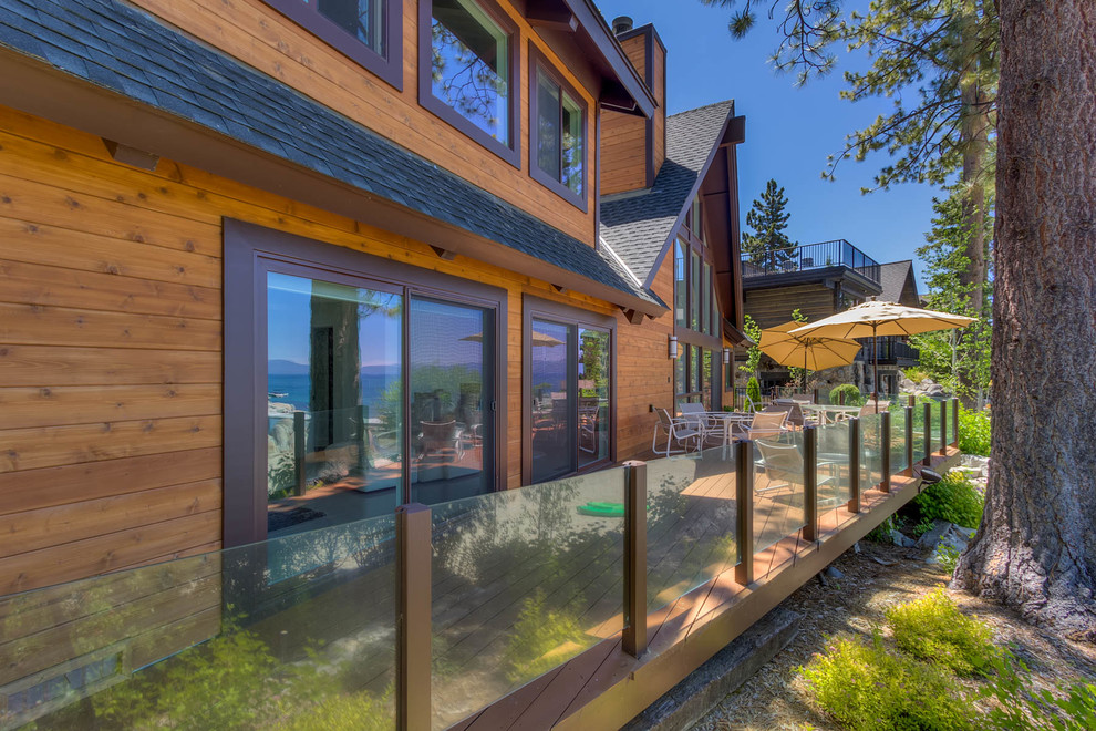 Example of a large mountain style backyard deck design with no cover