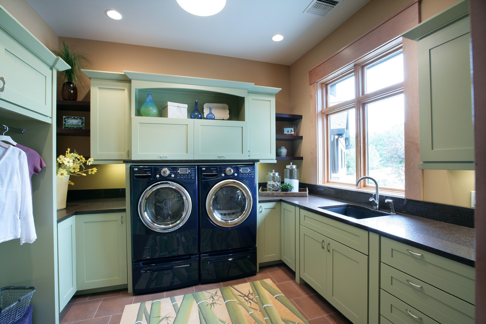 Inspiration for a transitional laundry room in Grand Rapids with green cabinets.