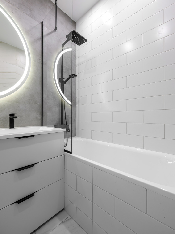 Inspiration for a small contemporary ensuite bathroom in Other with flat-panel cabinets, white cabinets, an alcove bath, a shower/bath combination, a wall mounted toilet, white tiles, white walls, an integrated sink, grey floors, a single sink and a freestanding vanity unit.