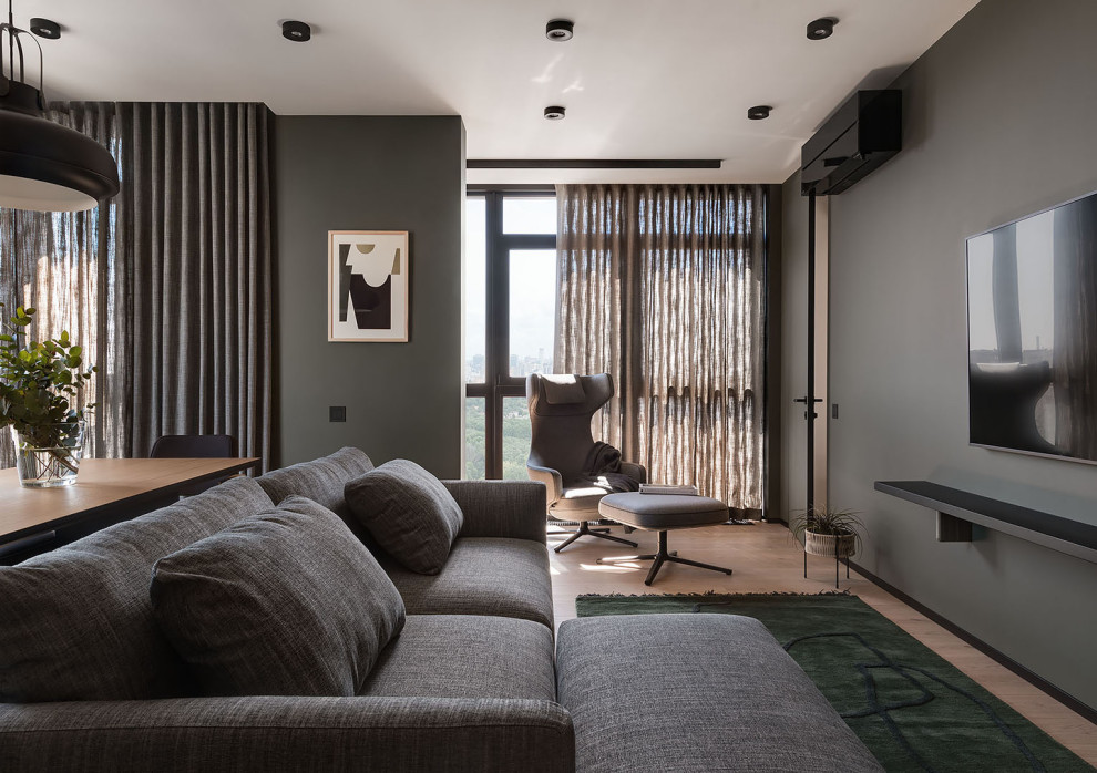 Medium sized scandi living room in Other with a reading nook, grey walls, light hardwood flooring, a wall mounted tv, beige floors and feature lighting.