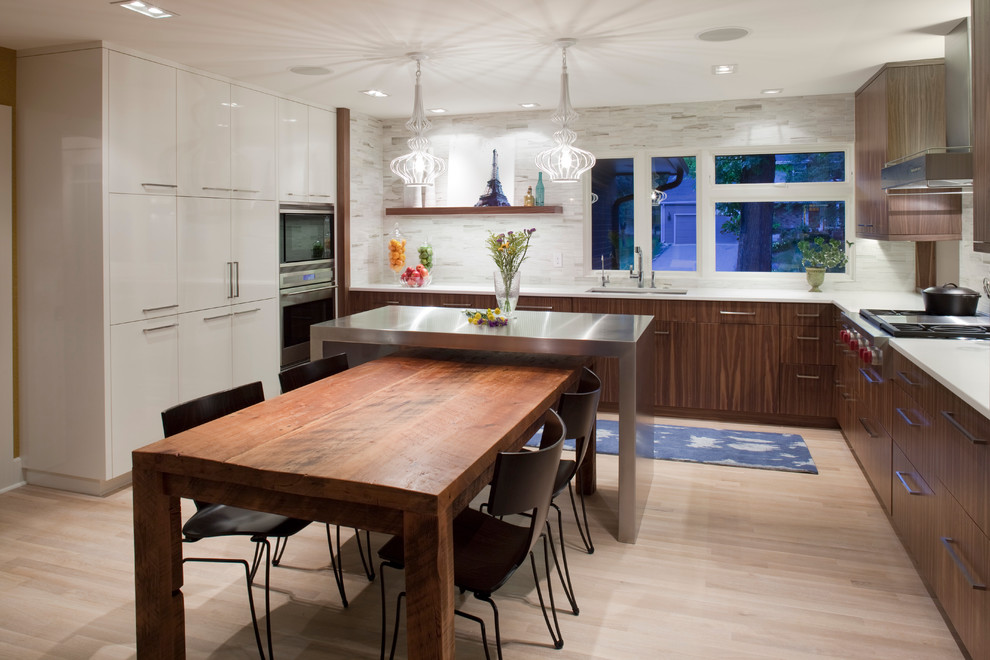 Inspiration for a contemporary eat-in kitchen in Minneapolis with flat-panel cabinets and stainless steel appliances.