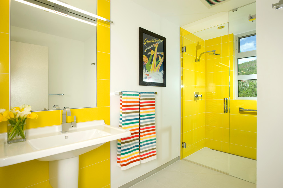 Modern kids bathroom in Denver with a pedestal sink and yellow tile.