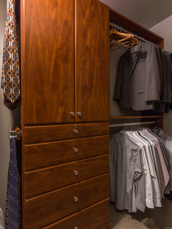 Design ideas for a small transitional gender-neutral walk-in wardrobe in Chicago with flat-panel cabinets, light wood cabinets and carpet.