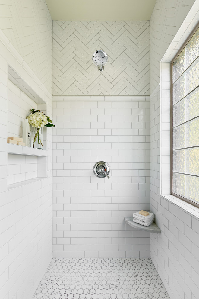 Photo of a mid-sized transitional master bathroom in Charlotte with white tile, ceramic tile, porcelain floors, grey floor, a shower seat and a niche.