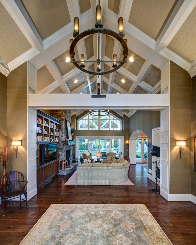 Photo of a large traditional foyer in Orange County with beige walls, dark hardwood floors and brown floor.