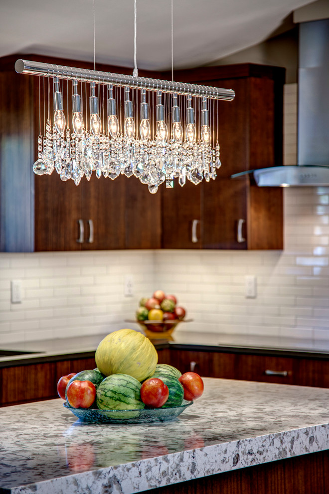 Eat-in kitchen - small transitional l-shaped medium tone wood floor eat-in kitchen idea in Seattle with a single-bowl sink, flat-panel cabinets, dark wood cabinets, quartz countertops, white backsplash, ceramic backsplash, stainless steel appliances and an island
