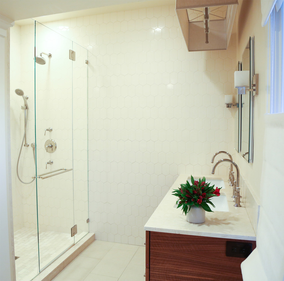 This is an example of a mid-sized contemporary master bathroom in San Francisco with a drop-in sink, flat-panel cabinets, medium wood cabinets, an alcove shower, white tile and white walls.
