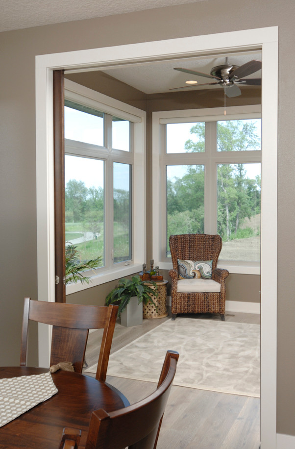 Enclosed dining room - mid-sized transitional medium tone wood floor enclosed dining room idea with gray walls and no fireplace