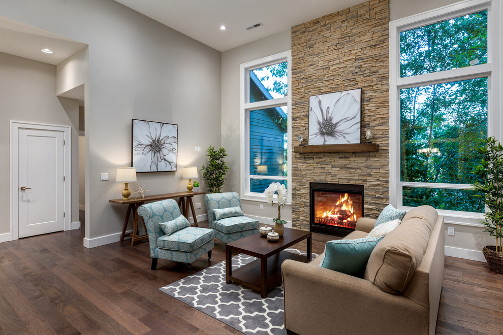 Photo of a large contemporary open concept living room in Portland with grey walls, medium hardwood floors, a standard fireplace, a brick fireplace surround and brown floor.