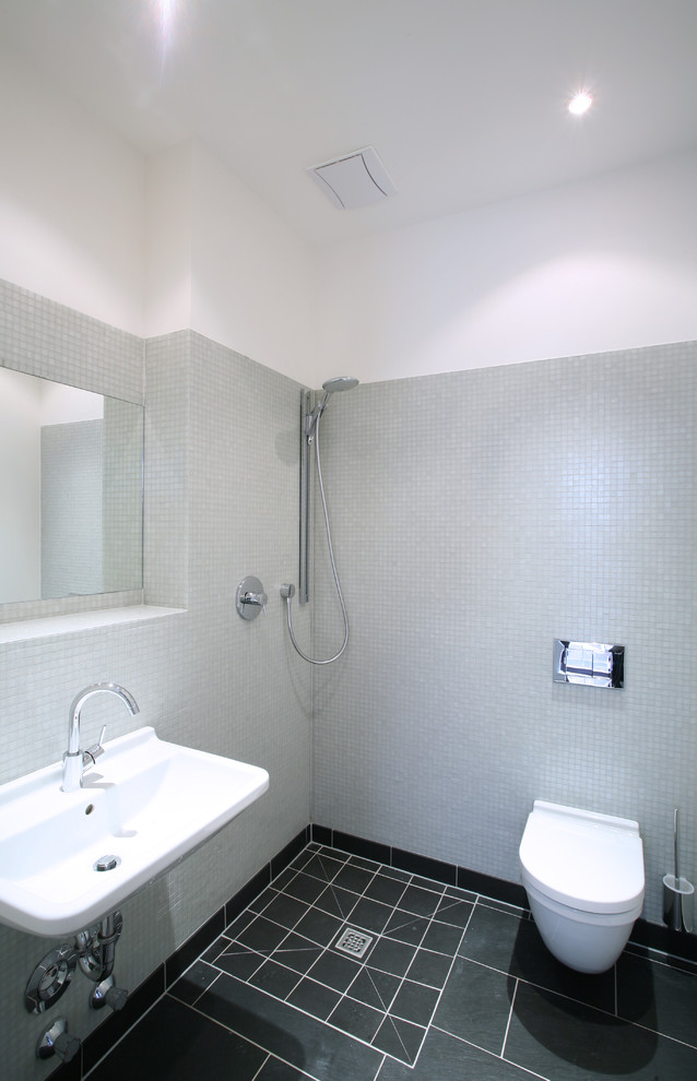 Duschbad With Wandwaschbecken, bodengleicher Dusche, grauen Fliesen, weißer Wandfarbe, Keramikboden, Mosaikfliesen and Wandtoilette in Cologne