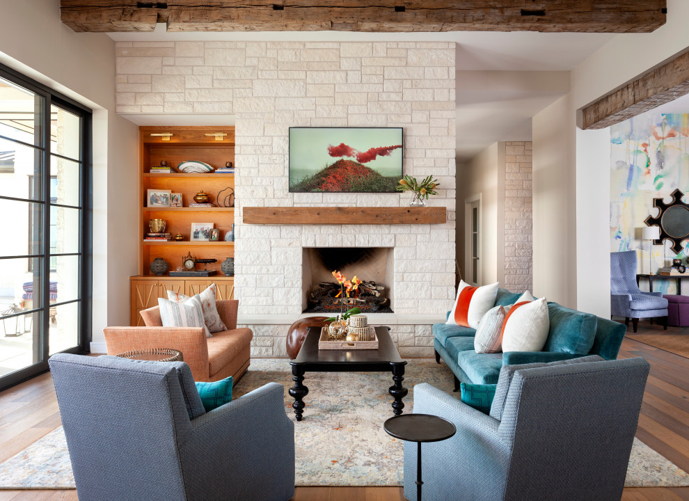 Expansive transitional open concept living room in Austin with white walls, a standard fireplace, a brick fireplace surround, a wall-mounted tv, brown floor and brick walls.