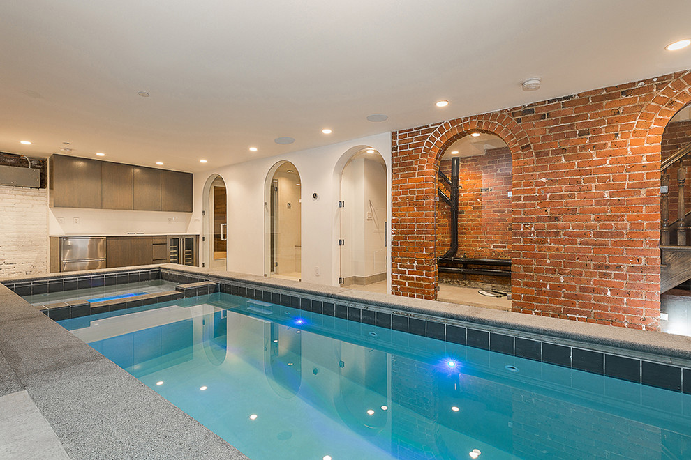 This is an example of a mid-sized modern indoor rectangular lap pool with a hot tub.