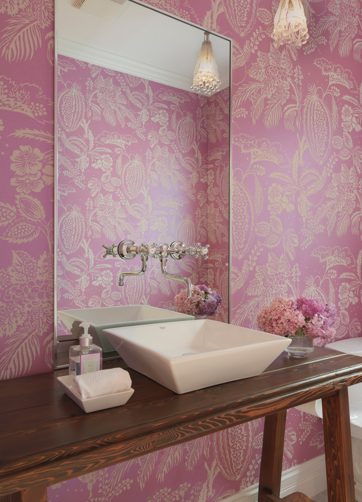Inspiration for a country powder room remodel in Providence with a vessel sink, wood countertops, pink walls and brown countertops