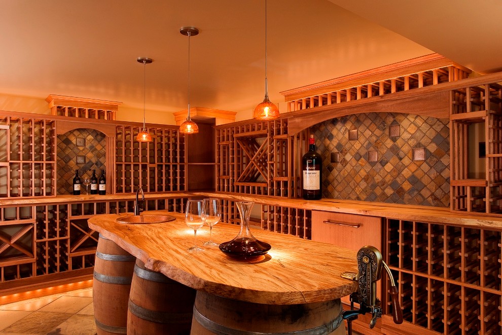 This is an example of a large country wine cellar in Seattle with slate floors and storage racks.