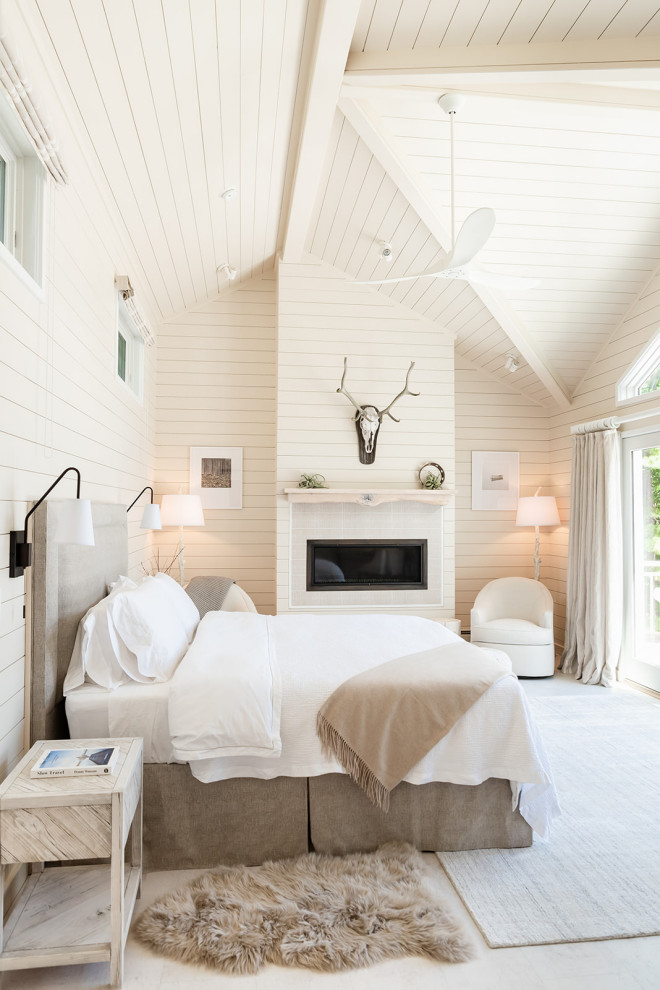 Inspiration for a large beach style master bedroom in Burlington with beige walls, light hardwood flooring, a standard fireplace, a timber clad chimney breast, white floors, a timber clad ceiling and tongue and groove walls.