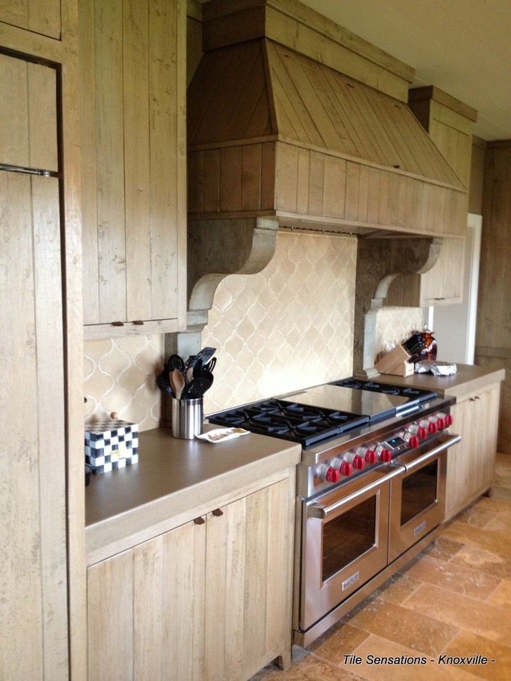 Kitchen - large rustic travertine floor kitchen idea with light wood cabinets, brown backsplash, cement tile backsplash, concrete countertops and stainless steel appliances
