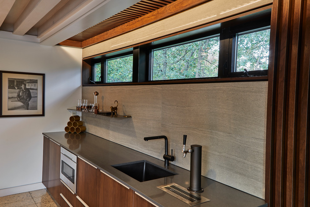 Photo of a mid-sized midcentury single-wall wet bar in Other with an undermount sink, flat-panel cabinets, dark wood cabinets, quartz benchtops, grey splashback, porcelain splashback and concrete floors.