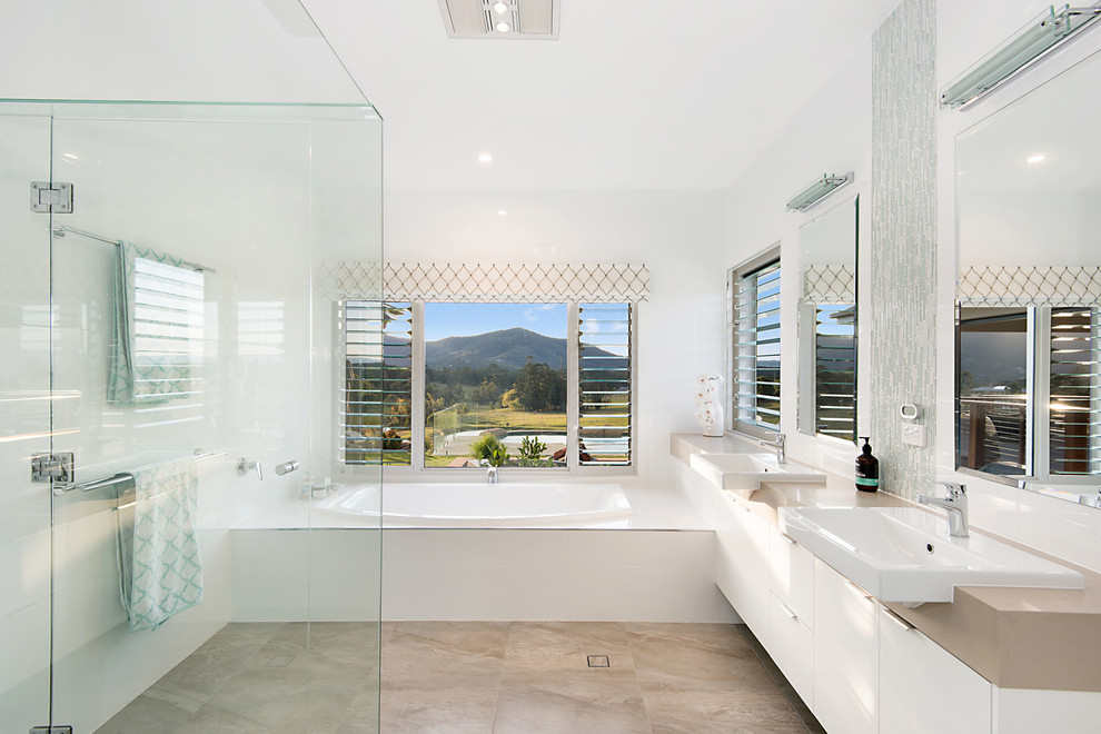 Design ideas for a mid-sized contemporary master bathroom in Brisbane with flat-panel cabinets, white cabinets, a drop-in tub, a corner shower, white walls, a drop-in sink and an open shower.