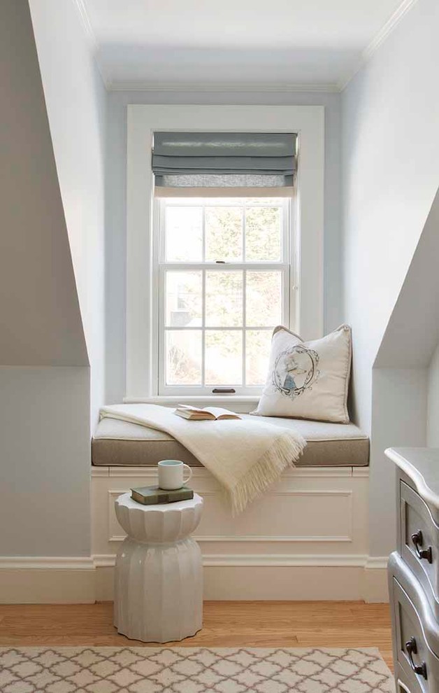 Inspiration for a traditional bedroom in Boston with blue walls and light hardwood floors.