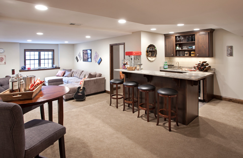 This is an example of a large arts and crafts galley seated home bar in Minneapolis with an undermount sink, dark wood cabinets, granite benchtops and ceramic floors.