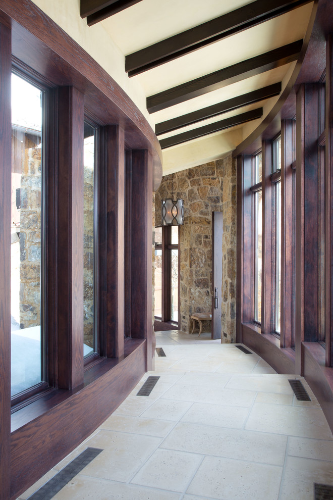 Hallway - rustic beige floor hallway idea in Denver with beige walls