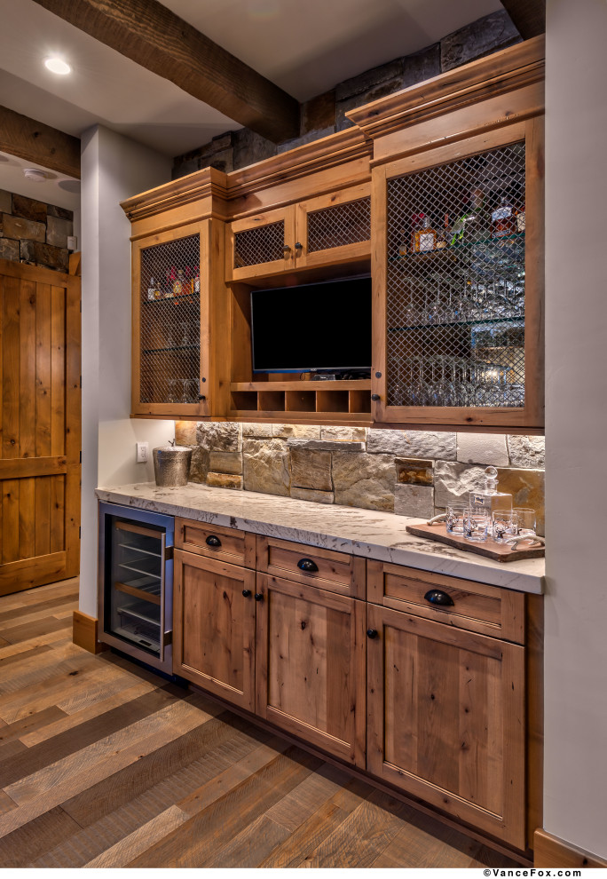 Photo of a small contemporary single-wall home bar in Other with no sink, shaker cabinets, light wood cabinets, granite benchtops, beige splashback, slate splashback, light hardwood floors, grey floor and white benchtop.