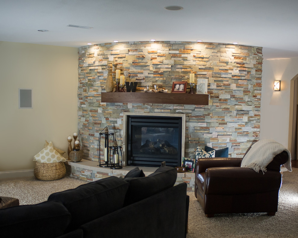 Inspiration for a large modern look-out basement in Other with beige walls, carpet, a standard fireplace and a stone fireplace surround.