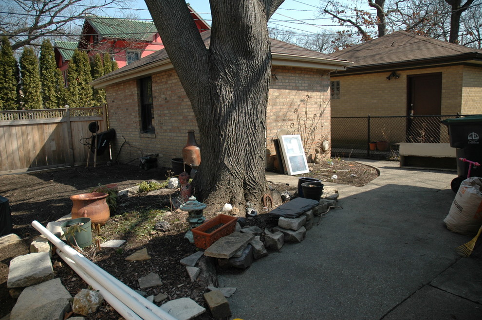 Photo of a small transitional backyard partial sun garden in Chicago with brick pavers.