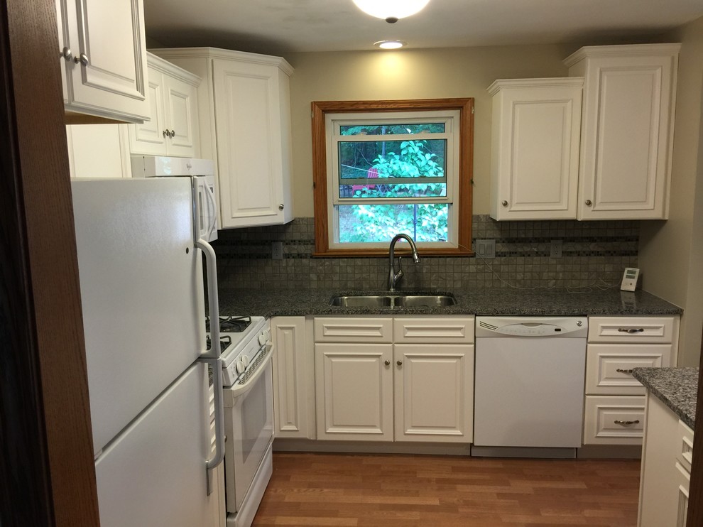 Inspiration for a small transitional l-shaped eat-in kitchen remodel with an undermount sink, raised-panel cabinets, white cabinets, granite countertops, gray backsplash, porcelain backsplash, white appliances and a peninsula